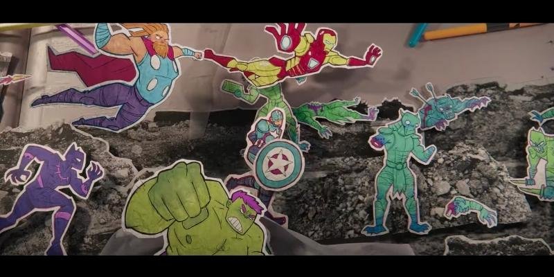 Screenshot of the animated sequence in ms. Marvel episode 1. Shows the avengers fighting thanos's army, with bright, colorful paper cut-outs of all the characters