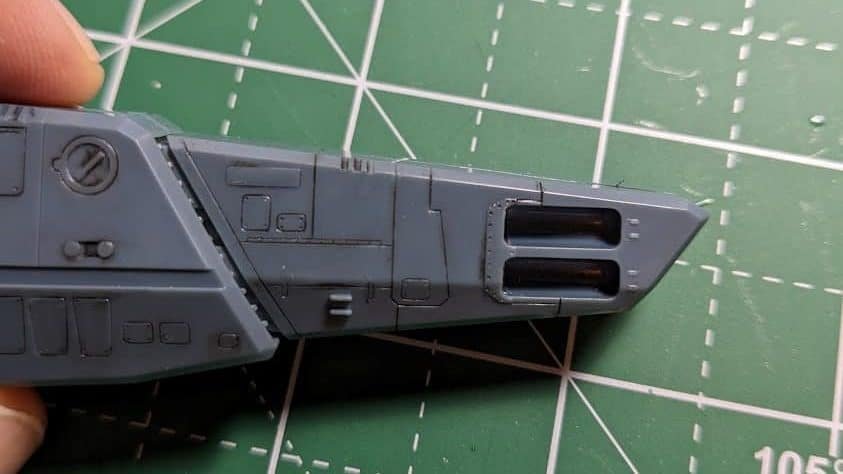A grey model kit piece with black panel-lining ink added to high light the details