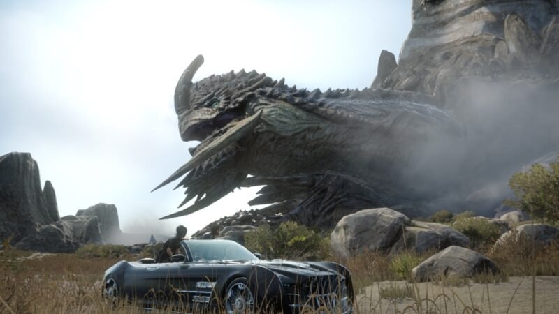 A promotional screenshot from final fantasy 15 featuring main character noctis in his convertible looking at a tortoise the size of a small mountain.