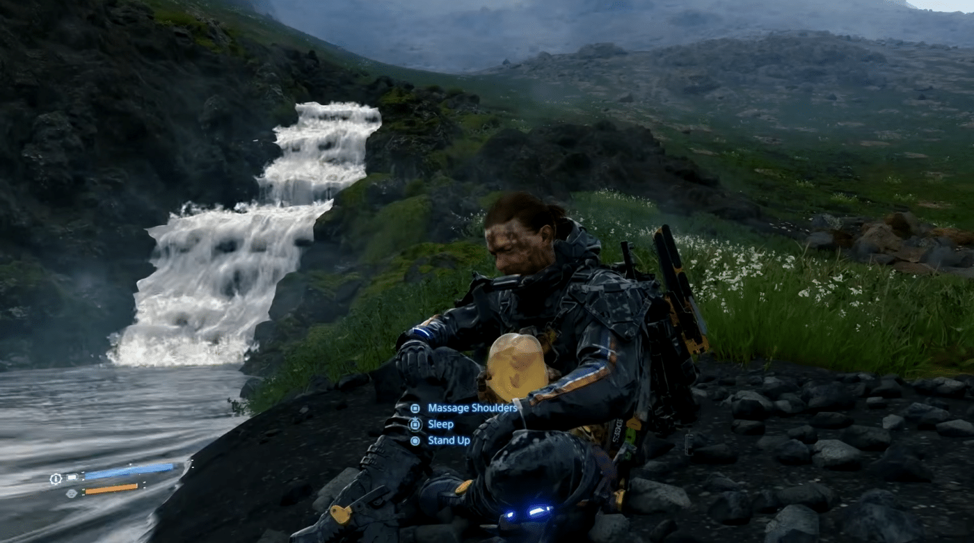 A screenshot from video game death stranding. A man in a full-body protective suit is resting at a riverbank, with options to massage his shoulders, sleep, or stand up.